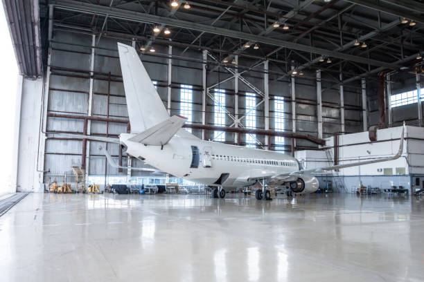 istock White passenger airplane under maintenance. Aircraft in the hangar. Checking mechanical systems for flight operations 1296959194