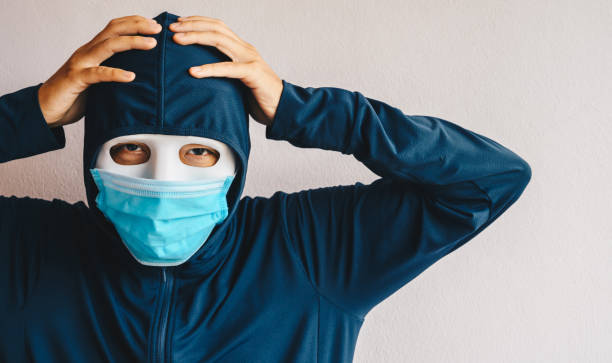 istock An unidentified mask man having headache or depressed. 1296959381