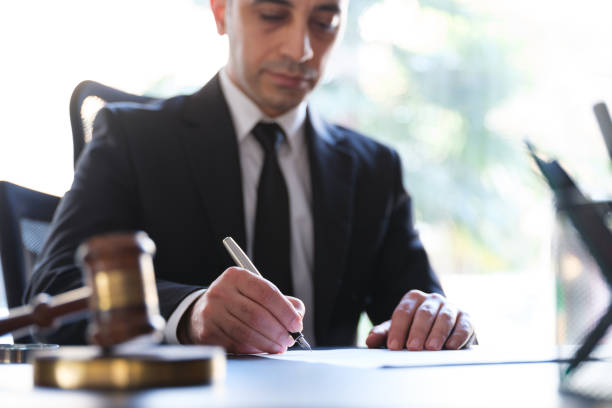 businessman signing legal paper in office - condition text magnifying glass contract imagens e fotografias de stock