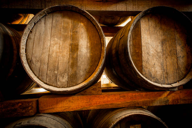 istock Wine barrels stacked in the old cellar of the winery. 1296964310