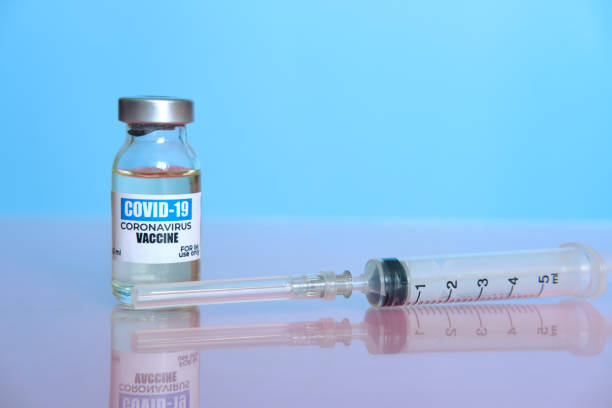 istock Ampoule with COVID-19 coronavirus vaccine, with a syringe for vaccination. 1296965231