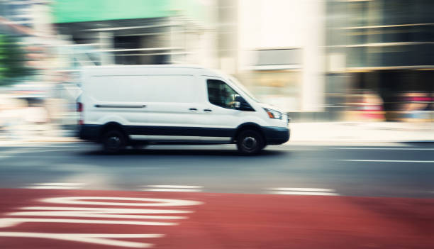 istock Commercial white van speeding in New York 1296965930