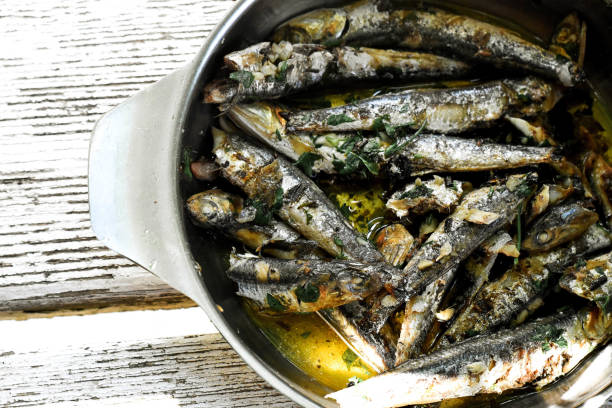 istock Crispy deep fried small fish on plate whit olive oils and parsley 1296969893