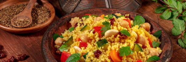 istock Couscous panorama with ingredients on a dark rustic wooden background 1296971273