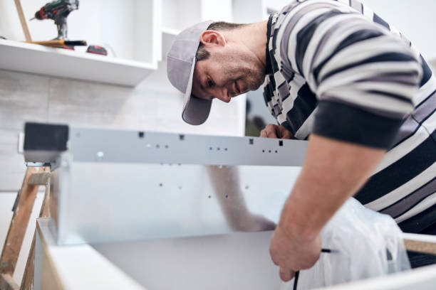 istock Handyman worker fixing and assembling household furniture. 1296974082
