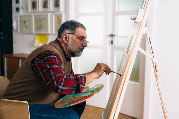 istock man painting picture at his home 1296976449