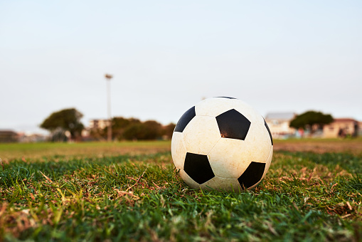 Closeup shot of a soccer ball on an empty sports field