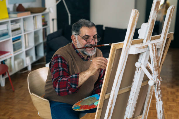 istock man painting picture at his home 1296977363