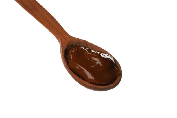 istock Spoon with caramel condensed milk isolated on white background 1296978531