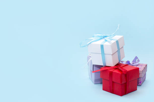 istock colorful gifts boxes on blue background with copy space 1296978893