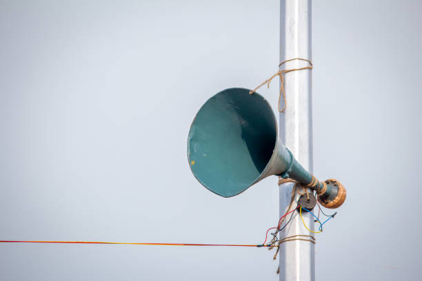 A loudspeaker attached to the lamp post along the Marina Beach for public announcements, Chennai, India A loudspeaker attached to the lamp post along the Marina Beach for public announcements, Chennai, India public address system stock pictures, royalty-free photos & images