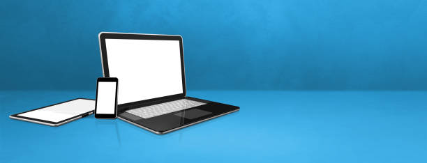 istock Laptop, mobile phone and digital tablet pc on blue office desk. Banner background 1296980992