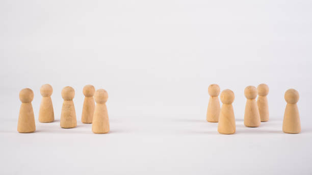 istock Two different groups of people standing facing to each other for equality and competition in business concept 1296981012