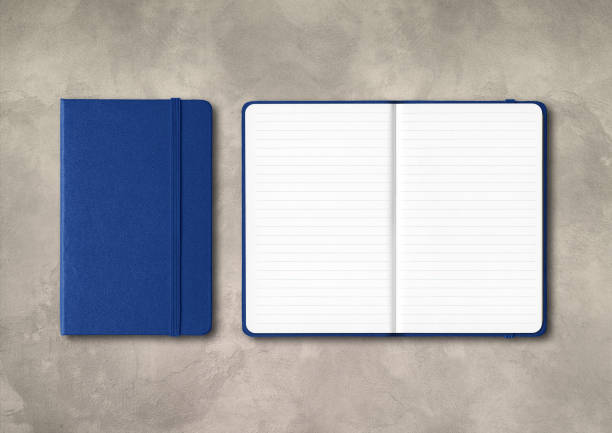 istock Marine blue closed and open lined notebooks on concrete background 1296981054