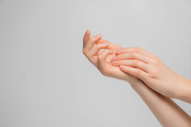 istock Woman applying hand cream for hands. 1296985951
