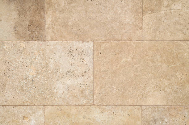 istock New  light brown stone wall  closeup in sunny day 1296986172