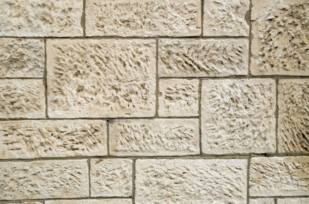 istock Old white stone wall  closeup in sunny day 1296986218