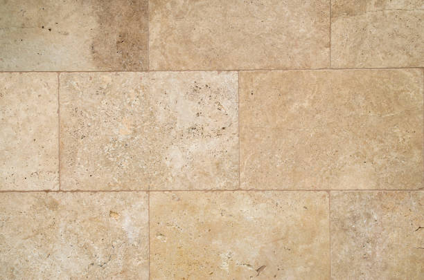 istock New  light brown stone wall  closeup in sunny day 1296986388