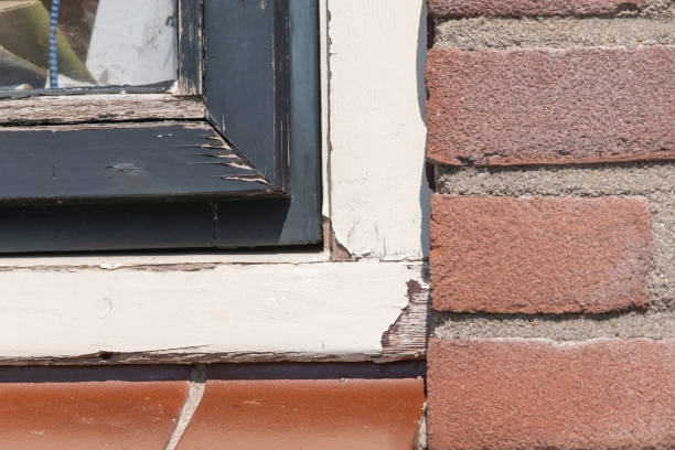istock Old unmaintained part of a window frame. Paint is peeling off, rotten frame. Deferred maintenance 1296987738