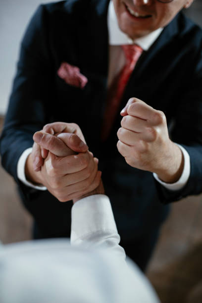 istock Close up of men handshake in office. 1296987753