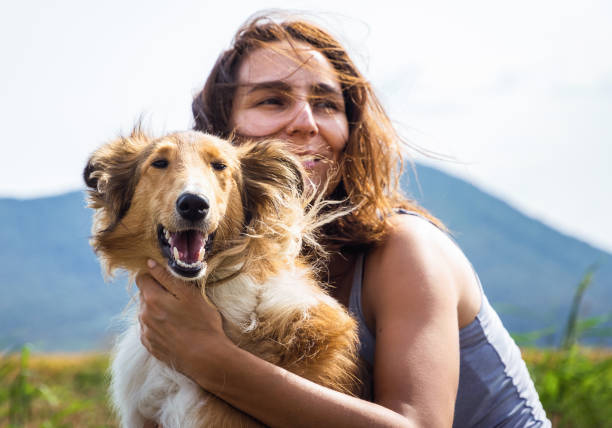 istock Young woman with dog 1296988421