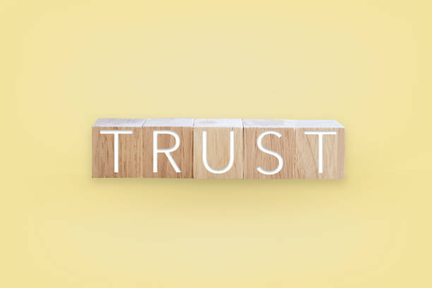 istock Trust word on wooden board with color background. Busines concept. 1296989366