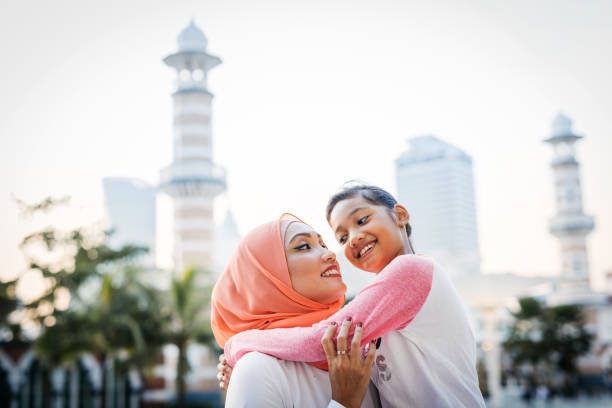 istock Malaysian mother with two daughters outdoors 1296990713