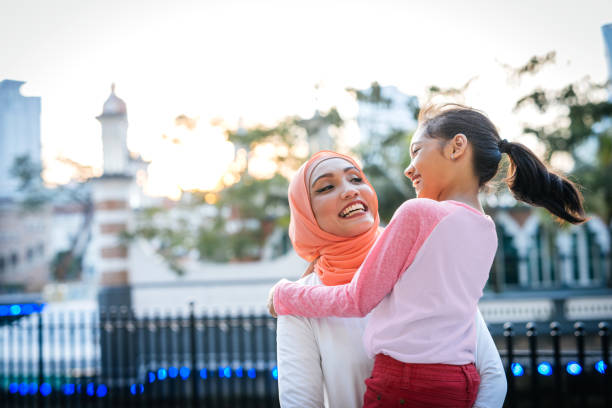 istock Malaysian mother with two daughters outdoors 1296990909