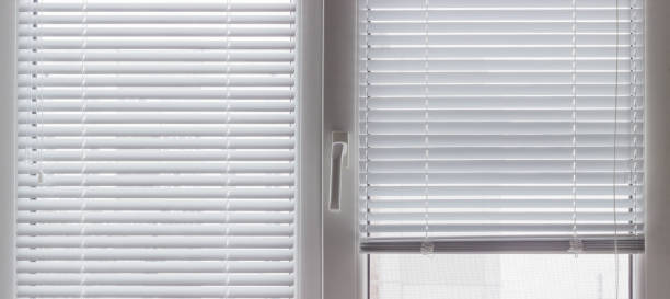 istock Fragment of modern window with Venetian blinds, inside view 1296991195
