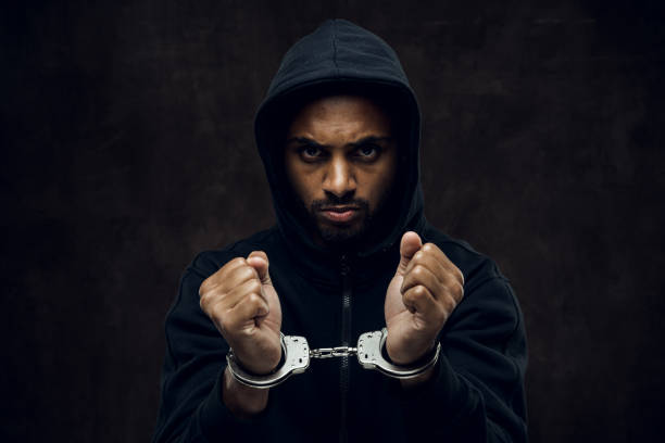 No more racism Afroamerican man wearing hoodie in handcuffs. Anti-racism concept. i cant breathe stock pictures, royalty-free photos & images