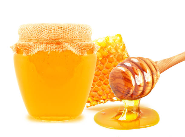 istock honeycomb and honey in a jar 1296993873