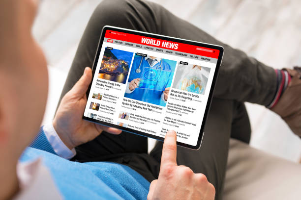 istock Man reading latest news on tablet 1296995511