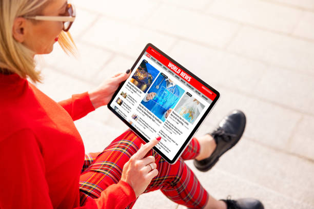 istock Woman reading news online on the tablet computer 1296995628