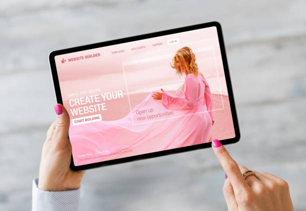 istock Woman building her website on tablet computer 1296995631