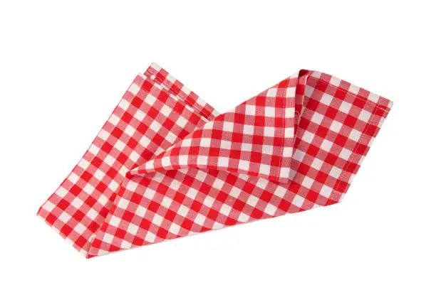 Photo of Red checkered folded cloth isolated on white,kitchen picnic towel top view.