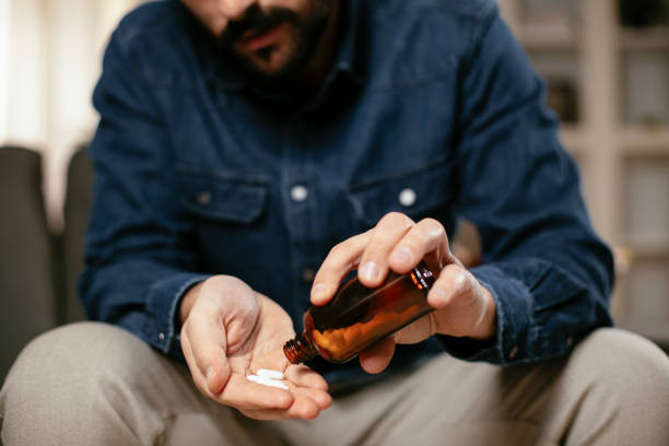 istock Young man drink medicine pill. 1296997111