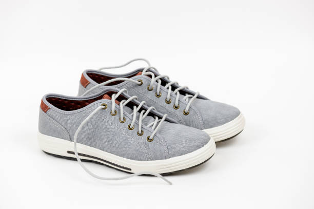 istock Gray sneakers on a white background 1297000959
