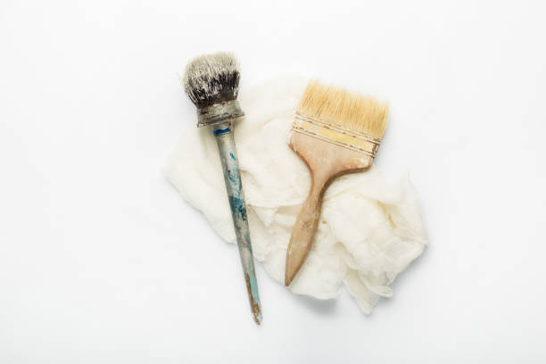 istock Paint brushes and rag on a white background. Banner. Flat lay, top view 1297002220