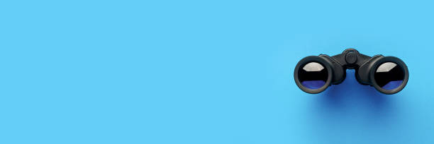 istock Binoculars on a light blue background. Banner. Flat lay, top view 1297002610