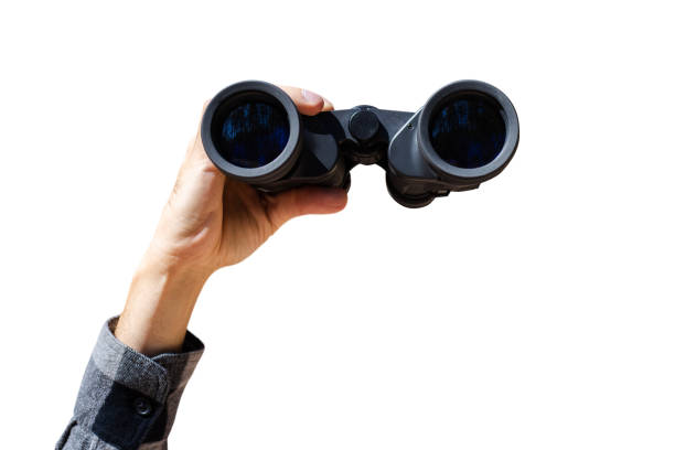 istock Male hand are holding binoculars on white isolated background. Banner. Flat lay, top view 1297002661