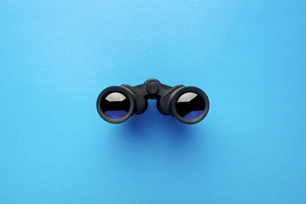 istock Binoculars on a light blue background. Banner. Flat lay, top view 1297002766