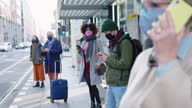 istock Group of people with face mask at tram station 1297002959