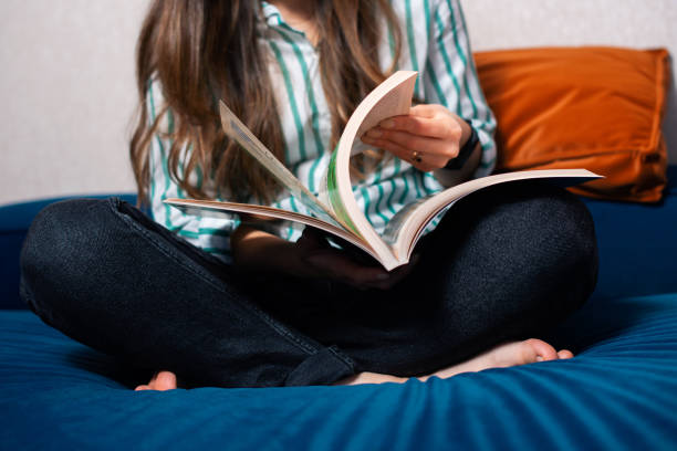 istock Close up selective focus of woman reading on sofa 1297003604