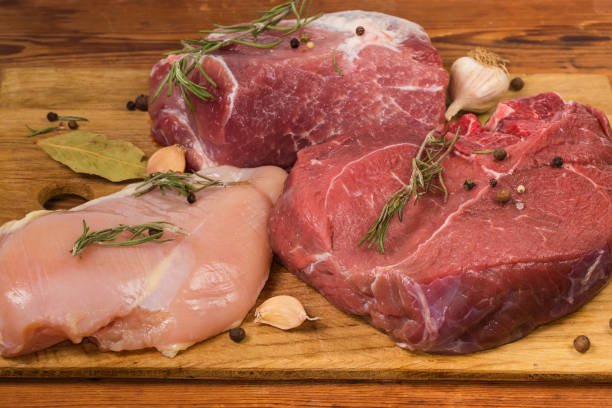 istock Different uncooked meat with spices on cutting board, close-up 1297004194