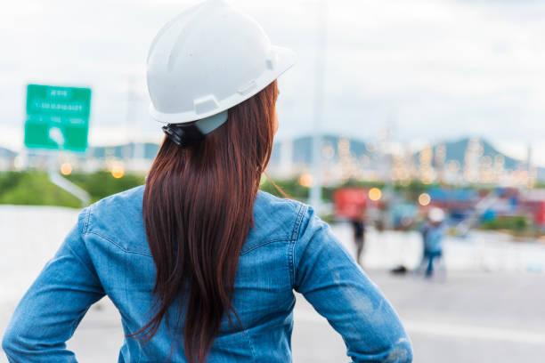 istock Woman engineer entrepreneur construction industry worker. Female engineer working refinery oil plant manufacturing. Young civil engineering construction wear hard hat safety helmet construction site. 1297004453