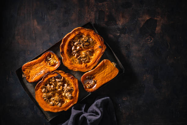 istock Pumpkin and butternut squash roasted oven on dark wooden background 1297005829