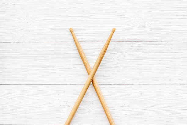 Two wooden drum sticks, top view. Music background.