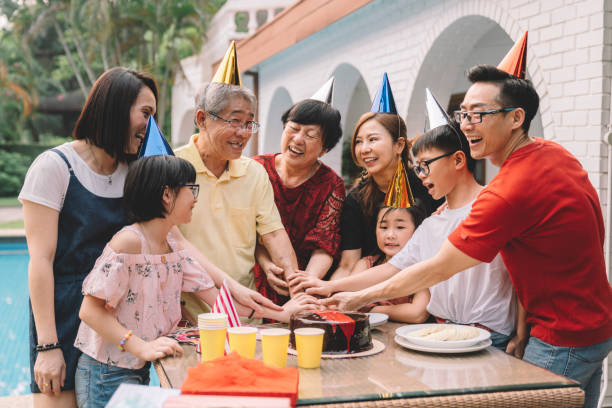 asian chinese multi-generation family celebrating grandpa's birthday celebrating birthday happy birthday cousin stock pictures, royalty-free photos & images