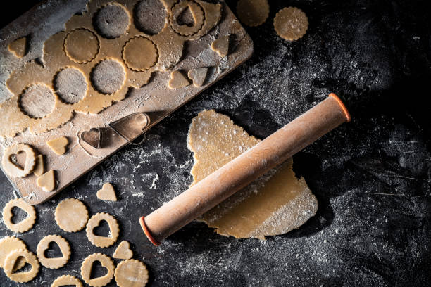 Bakery homemade linzer cookies biscuits with dough cutting shapes and rolling pin food preparation
