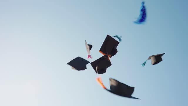 A group of graduates threw their hats to the sky to congratulate them on graduation.